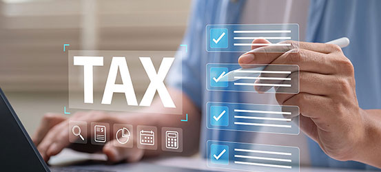 Close up of person using laptop with overlay illustration of tax checklists