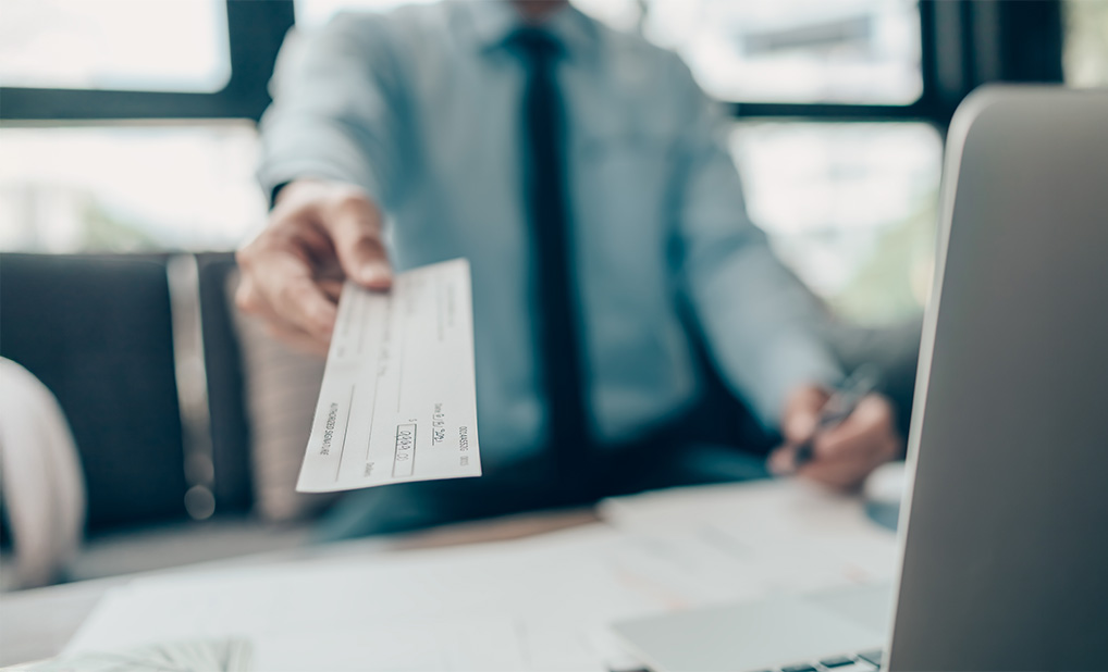 Close up of person holding check