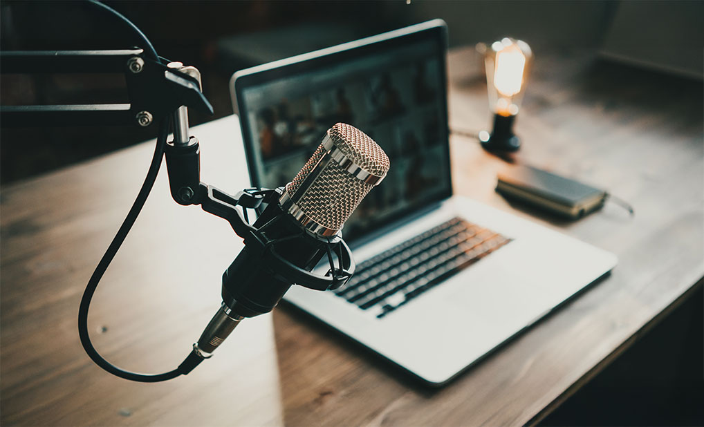Microphone next to laptop on desk