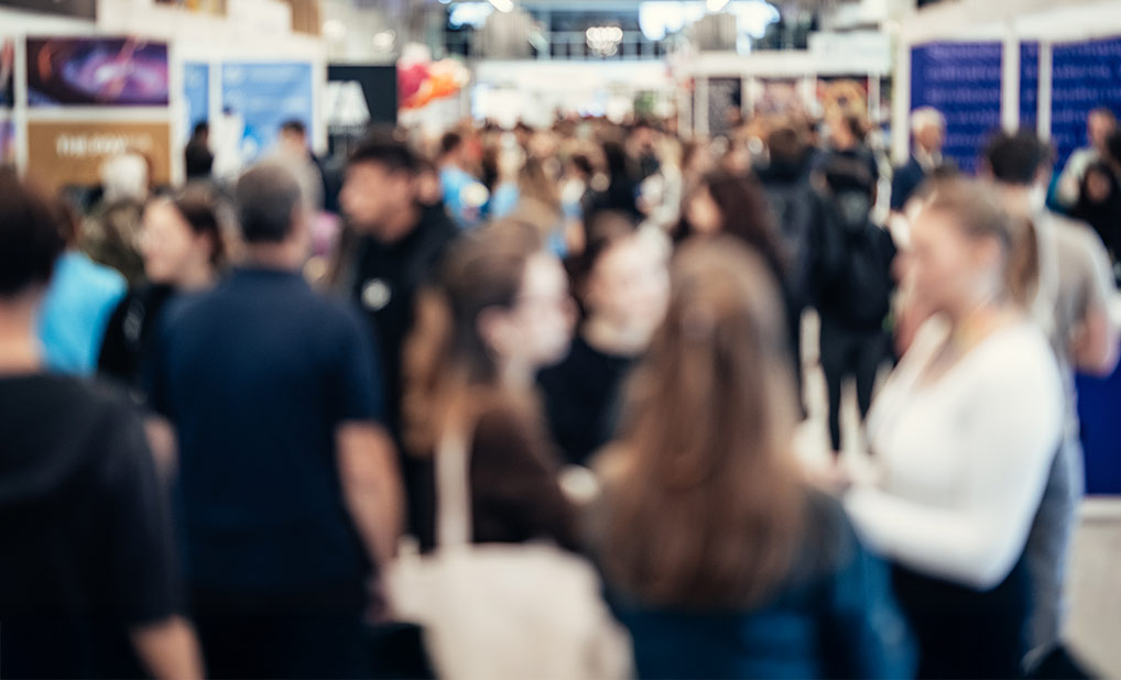 Abstract image of people in large meeting hall