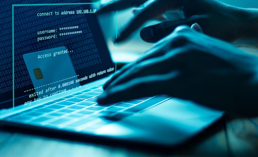 Close up of person using laptop and entering login credentials