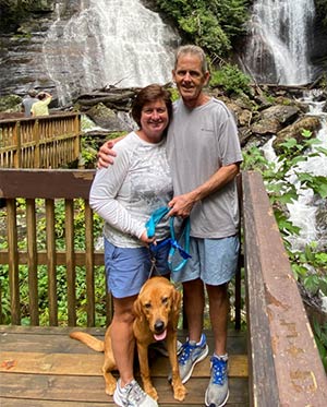 Todd Wilson and his wife standing before two waterfalls