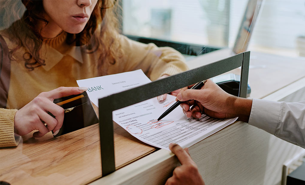 Person showing document to bank teller