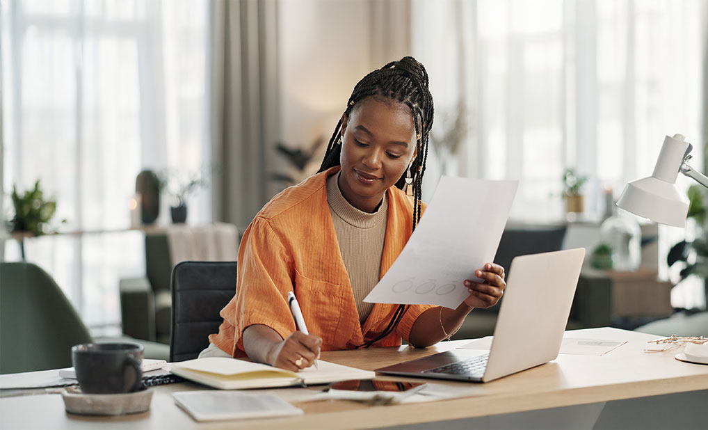 Businesswoman sitting at desk looking at papers