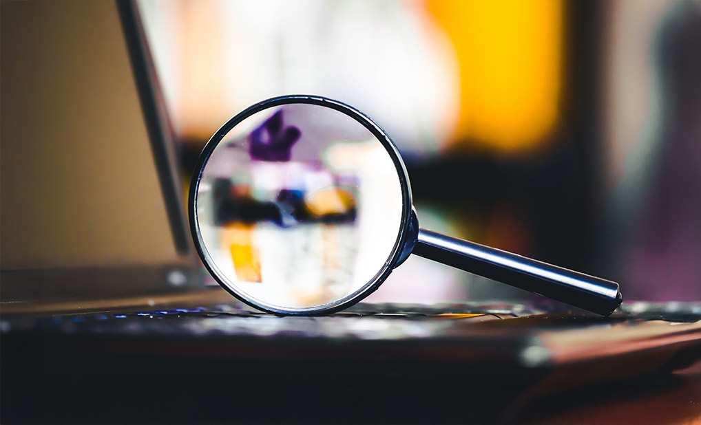 Magnifying glass on top of laptop keyboard