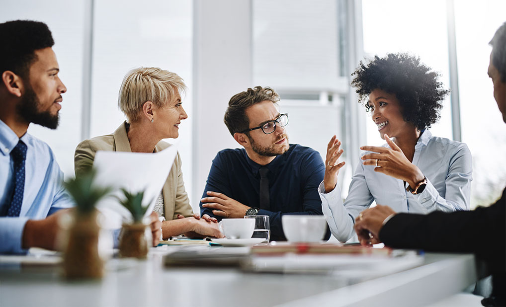 Group of business people at table talking