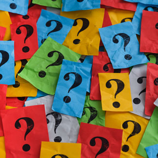 crumpled pieces of paper with question marks on them