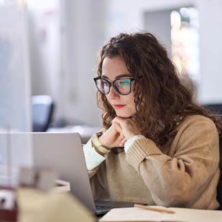 A woman studying a computer screen