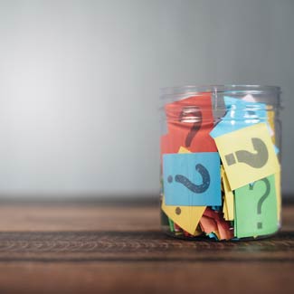 a jar full of scraps of paper with question marks on them