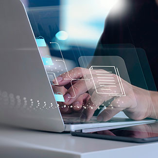 Hands typing on a laptop with a document icon superimposed