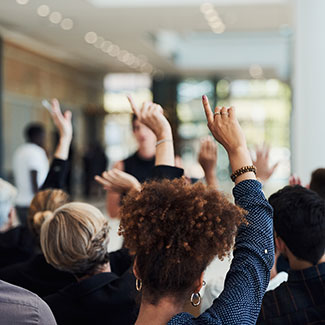 Crowd of people with their hands raised