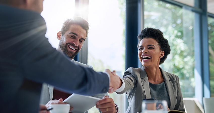 People shaking hands and being happy