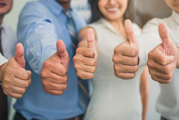 Five people showing thumbs up sign