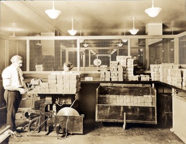 Man feeding bills into a mechanized counting machine
