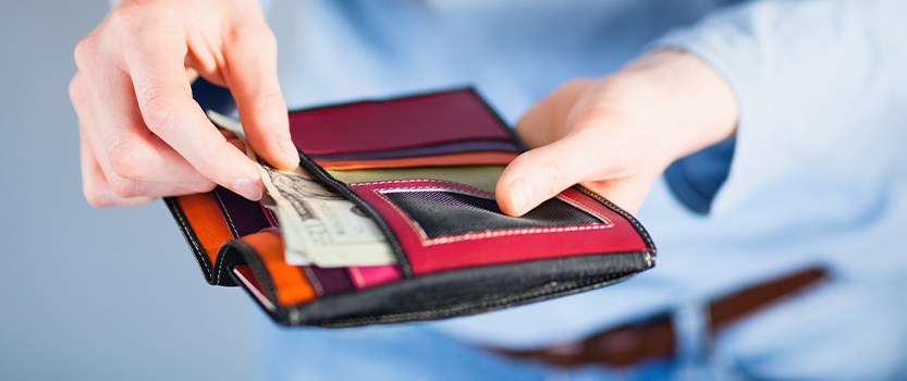 person removing cash from wallet