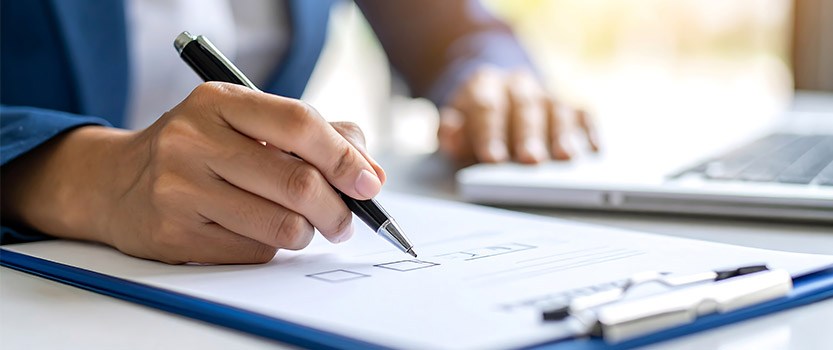 Close up of person signing checklist