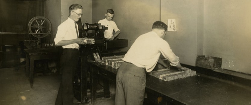 Group of men from the early 1900s packaging and organizing cash