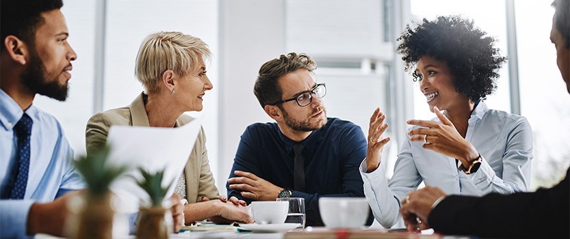 Group of business people at table talking