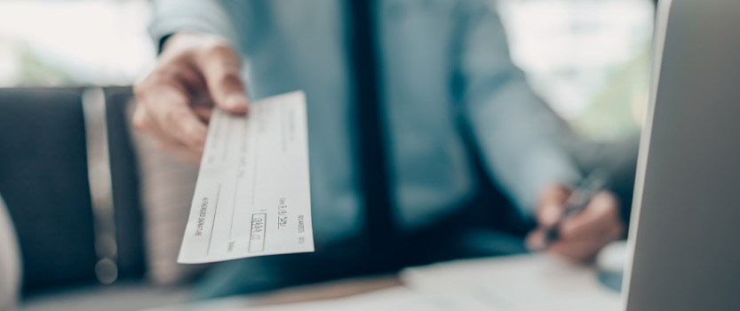 Close up of person holding check