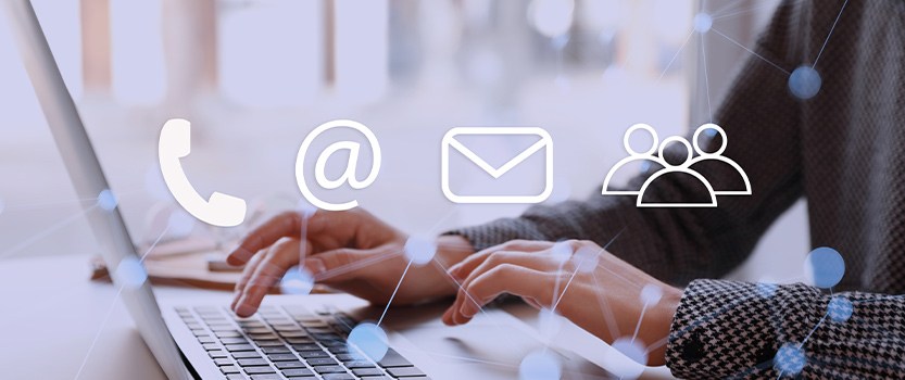 photo of person typing on laptop with phone, @ symbol, mail and people icons