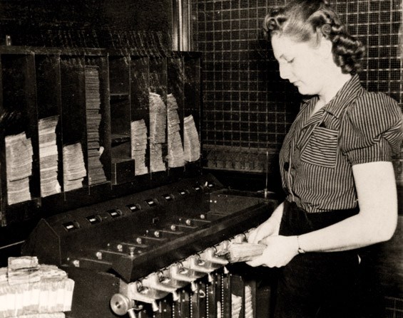 Woman from the early 1900s inspecting and verifying cash