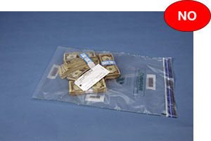 Incorrect example of a currency bag containing loose notes or a small deposit placed in a large bag with the tag inside the bag