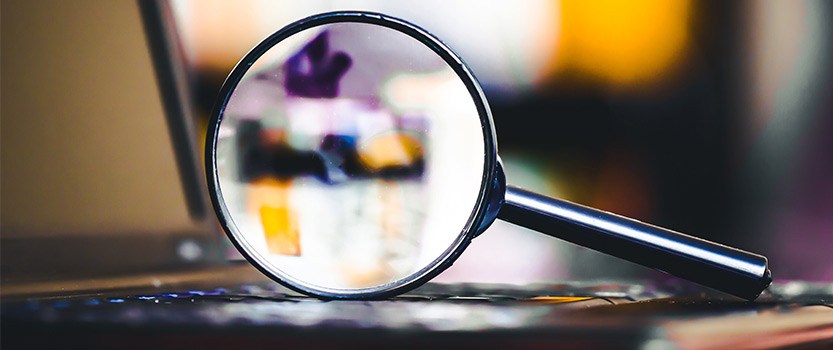 Magnifying glass on top of laptop keyboard