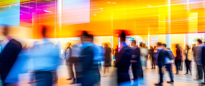 Abstract image of crowd of people walking in large hall