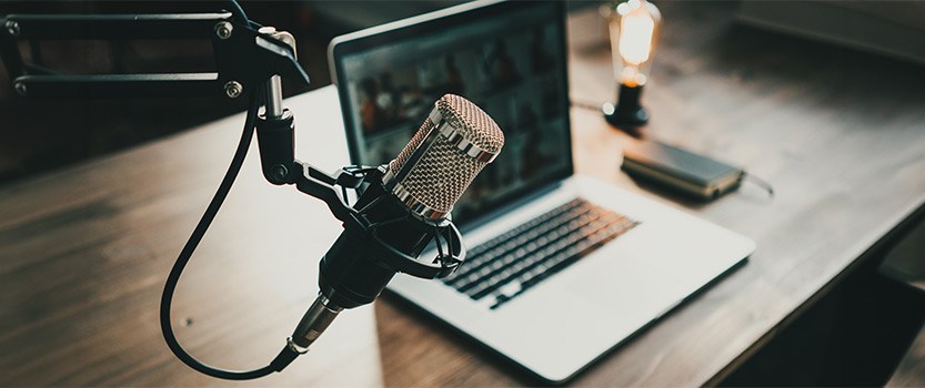 Microphone next to laptop on desk