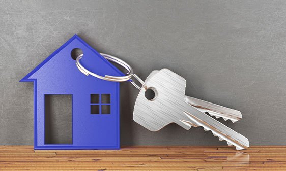 keychain shaped like a house, attached to a set of keys