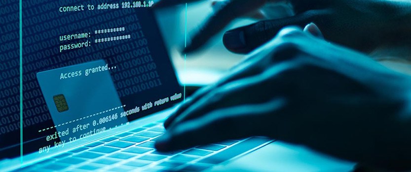 hands typing in account information on laptop