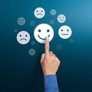 Finger touching a smiley face