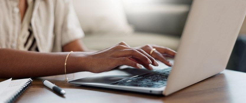 hands typing on laptop